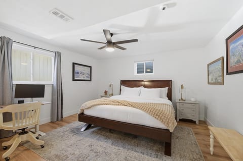 Spacious king bedroom with blackout curtains, sound machine, and dedicated workspace