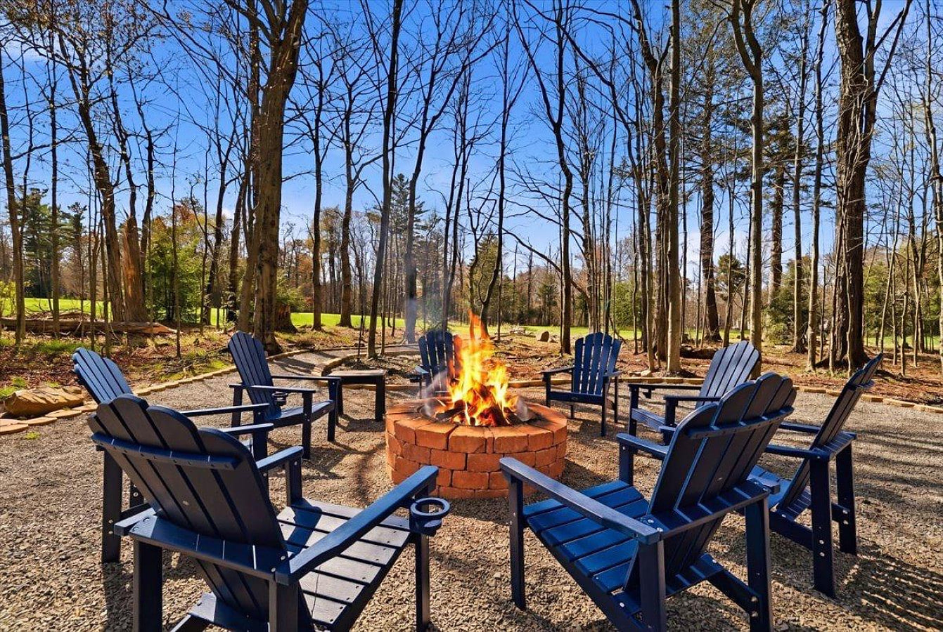 Cozy up around the backyard firepit and enjoy peaceful evenings with beautiful views of the Pocono Farms Golf Course.
