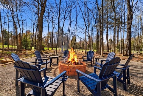Cozy up around the backyard firepit and enjoy peaceful evenings with beautiful views of the Pocono Farms Golf Course.