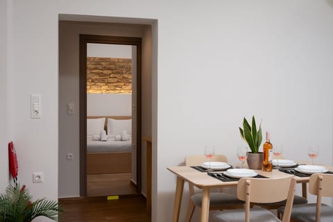 Modern dining nook with views into a cozy bedroom retreat