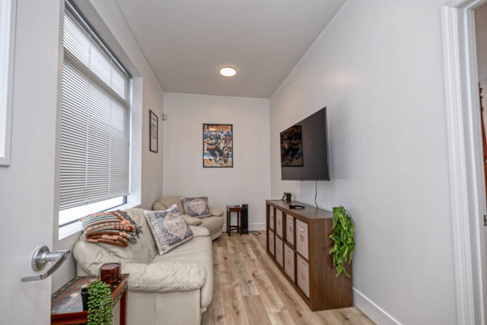 Bright, cozy TV lounge with comfy seating and natural light