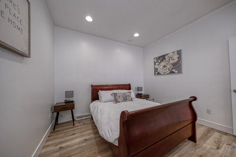 Bright, cozy bedroom with classic sleigh bed and modern finishes
