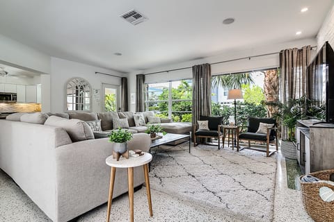 Floor-to-ceiling windows bring in natural light and lush garden views.