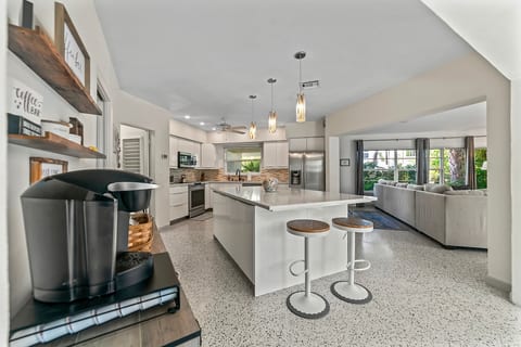 Bright open design – Kitchen island doubles as a casual dining space for quick bites or late-night snacks.