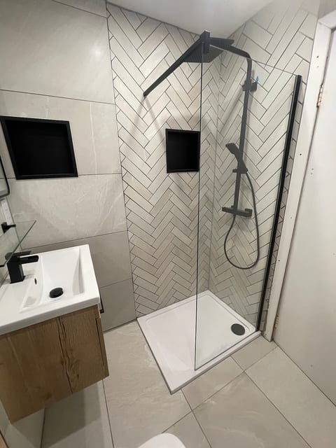 Stylish walk-in shower with herringbone tiles