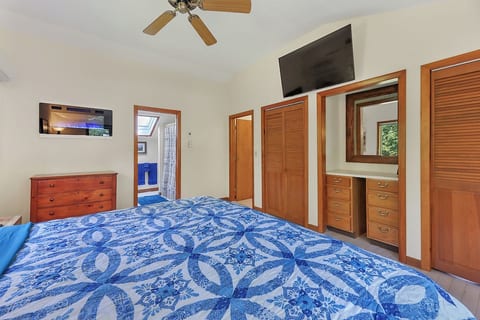 Master bedroom with flat-screen smart TV, private bathroom including bathtub and shower, closet space, dressers, an LED wall mount fireplace, and a wall unit minisplit system for heating and cooling.