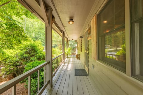 The covered front porch offers a welcoming place to sit back, relax, and enjoy the peaceful mountain setting.