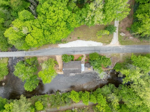 This aerial view showcases the full property, including the scenic junction where Little Snowbird Creek meets Snowbird Creek beside the cabin.
