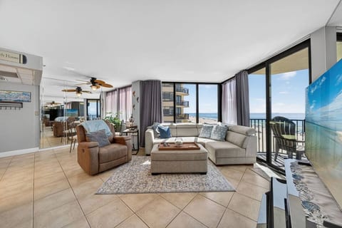Spacious living room with a queen size sleeper sofa, floor-to-ceiling windows, and panoramic Gulf views.