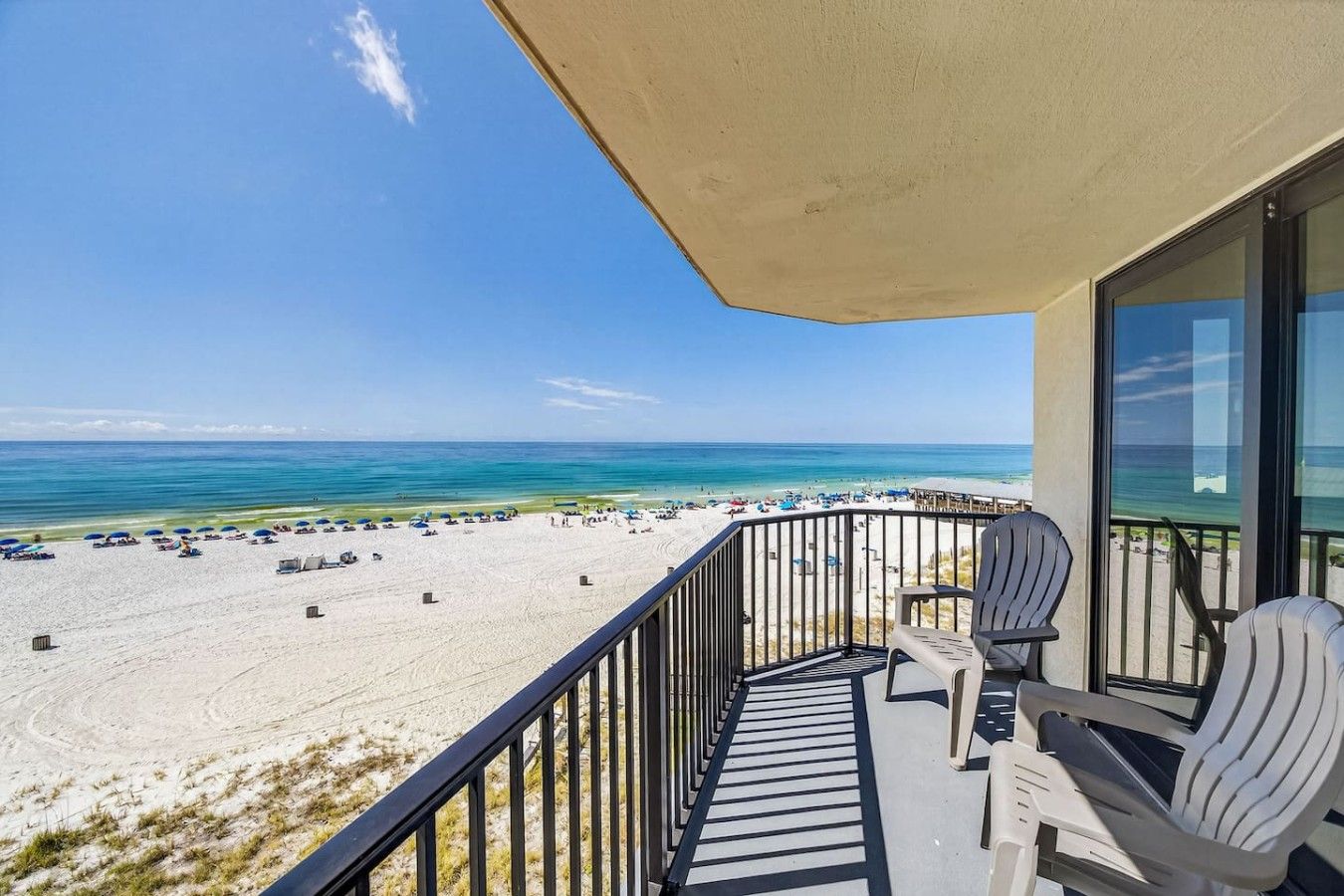 Spacious Gulf-front balcony with comfortable seating and panoramic beach views.