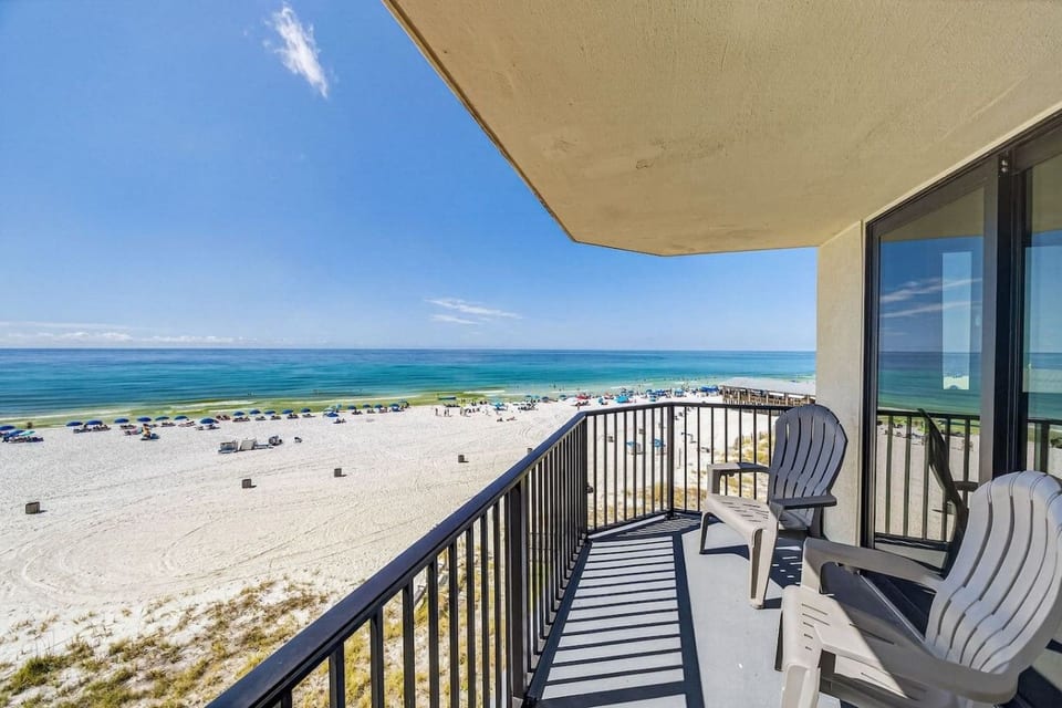 Spacious Gulf-front balcony with comfortable seating and panoramic beach views.
