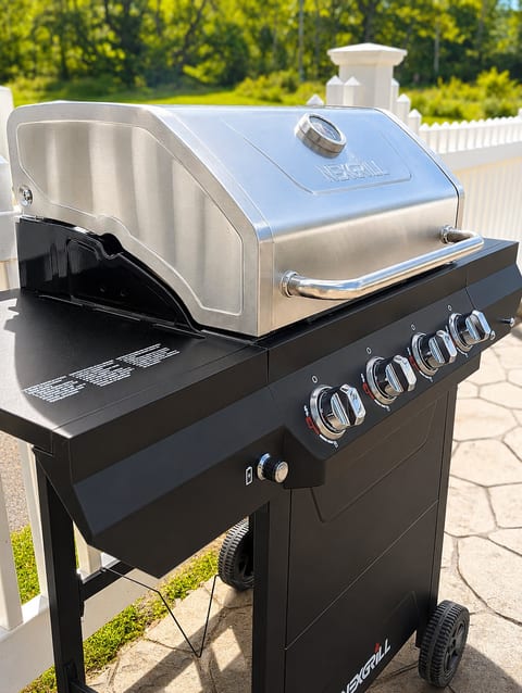 Sunny patio with a spacious gas grill for easy outdoor cookouts
