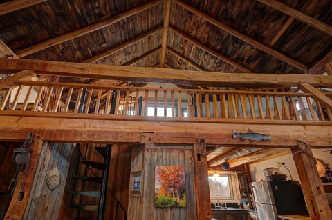 Looking up toward loft area with partial view of kitchen lower right. Note the spiral staircase.