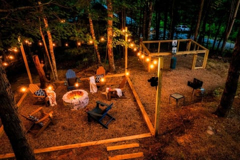 Private outdoor fire pit area with Adirondack chairs and string lights — perfect for evening gatherings under the stars