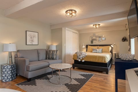 Suite featuring a queen size bed and cozy sofa