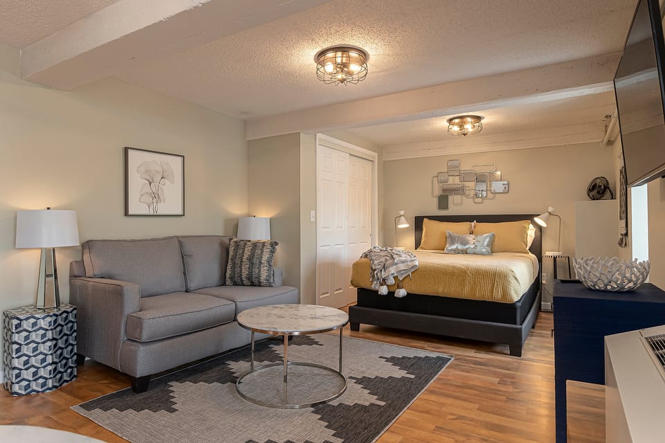 Suite featuring a queen size bed and cozy sofa 