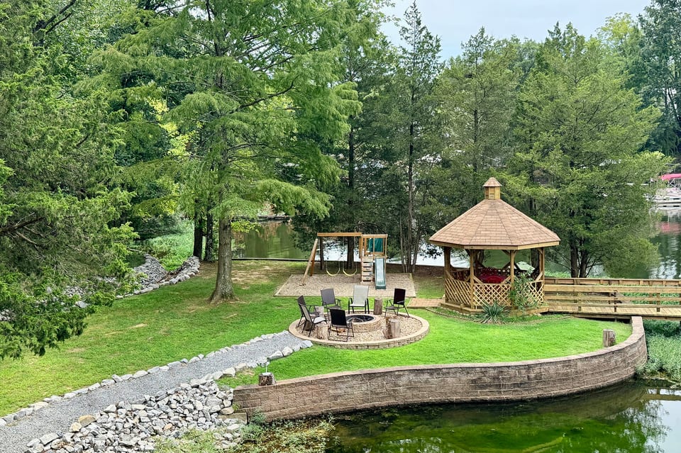Fire pit, playground and gazebo all on flat ground next to the water