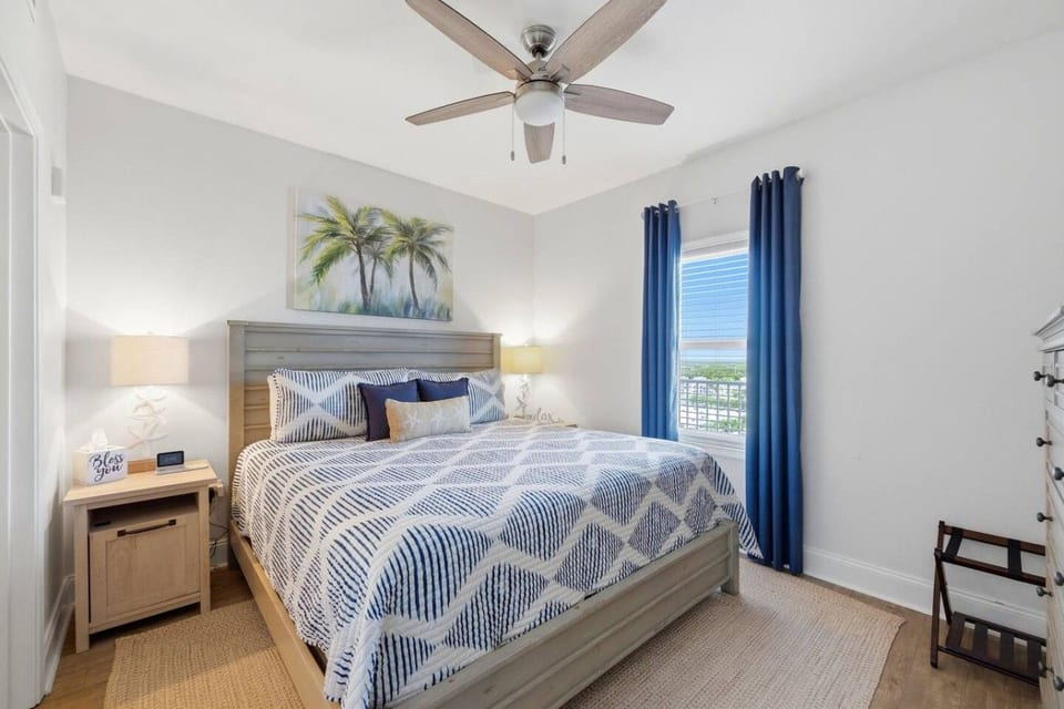 Coastal-inspired primary bedroom with a king-size bed and relaxing beach décor.