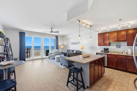 Bright open-concept living space with stunning Gulf views from the private balcony.