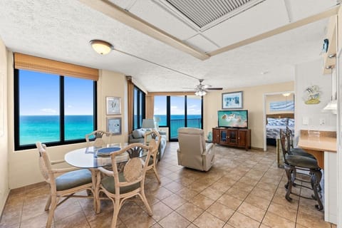 Spacious living and dining area with floor-to-ceiling Gulf views and plenty of natural light.