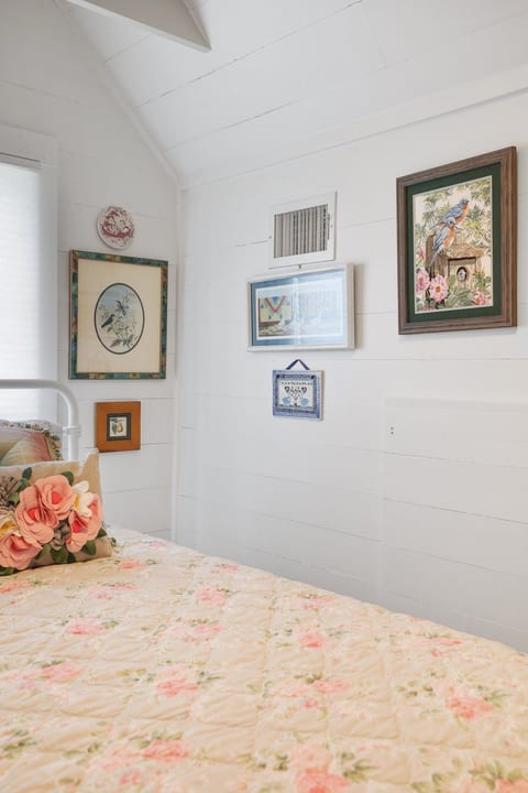 Charming cottage bedroom with floral bedding and bright, airy details