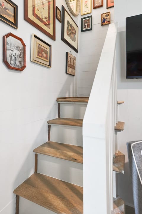 Charming staircase with warm wood steps and a curated gallery wall