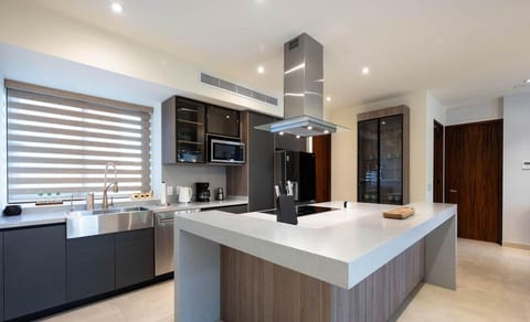 Fully equipped modern kitchen with sleek finishes, perfect for morning coffee, market finds, or a relaxed dinner at home between Puerto Vallarta adventures.
