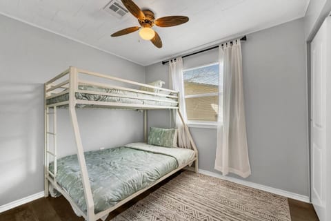 Fun and functional bedroom featuring a twin-over-full bunk bed—perfect for kids or extra guests. Includes fresh linens, extra blankets, and a cozy setup for a restful night’s sleep.
