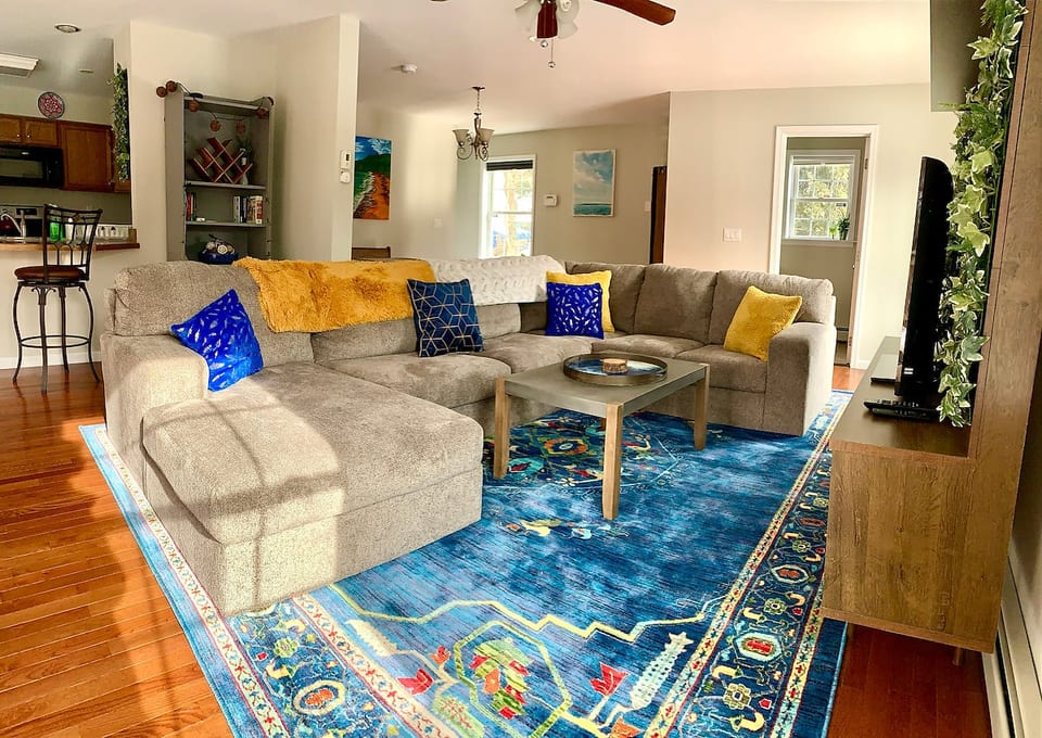 South-facing bright and airy living room. Enjoy the games and books on the bookshelf, or have Alexa fill you in on the latest news.