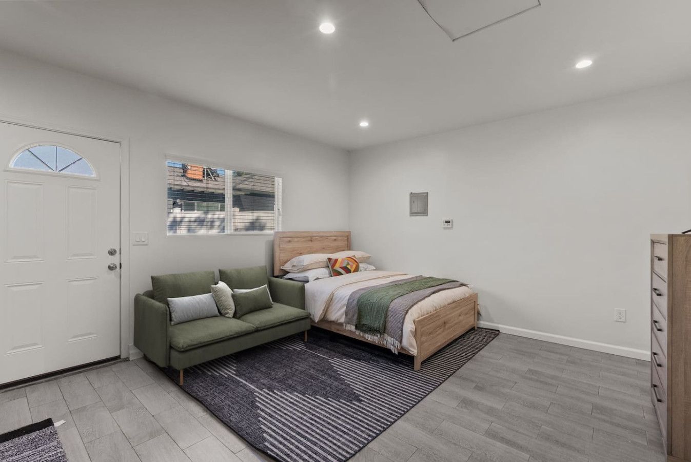 Relax in comfort: cozy bed meets comfy couch for your perfect stay.
