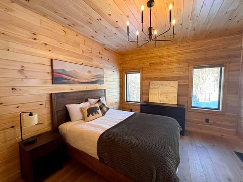The queen bedroom is located on the main level and is near a shared bathroom with shower. 