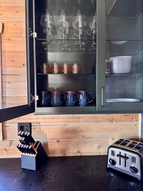 Plenty of mugs, wine glasses, and other dishware for all guests.