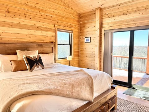 The primary bedroom is located on the main floor. It includes a king bed with balcony and private ensuite full bath with standalone soaking tub, oversized shower with double heads, and double vanity.