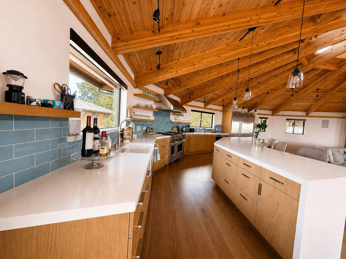 Spacious chef’s kitchen with vaulted wood ceilings and a large island
