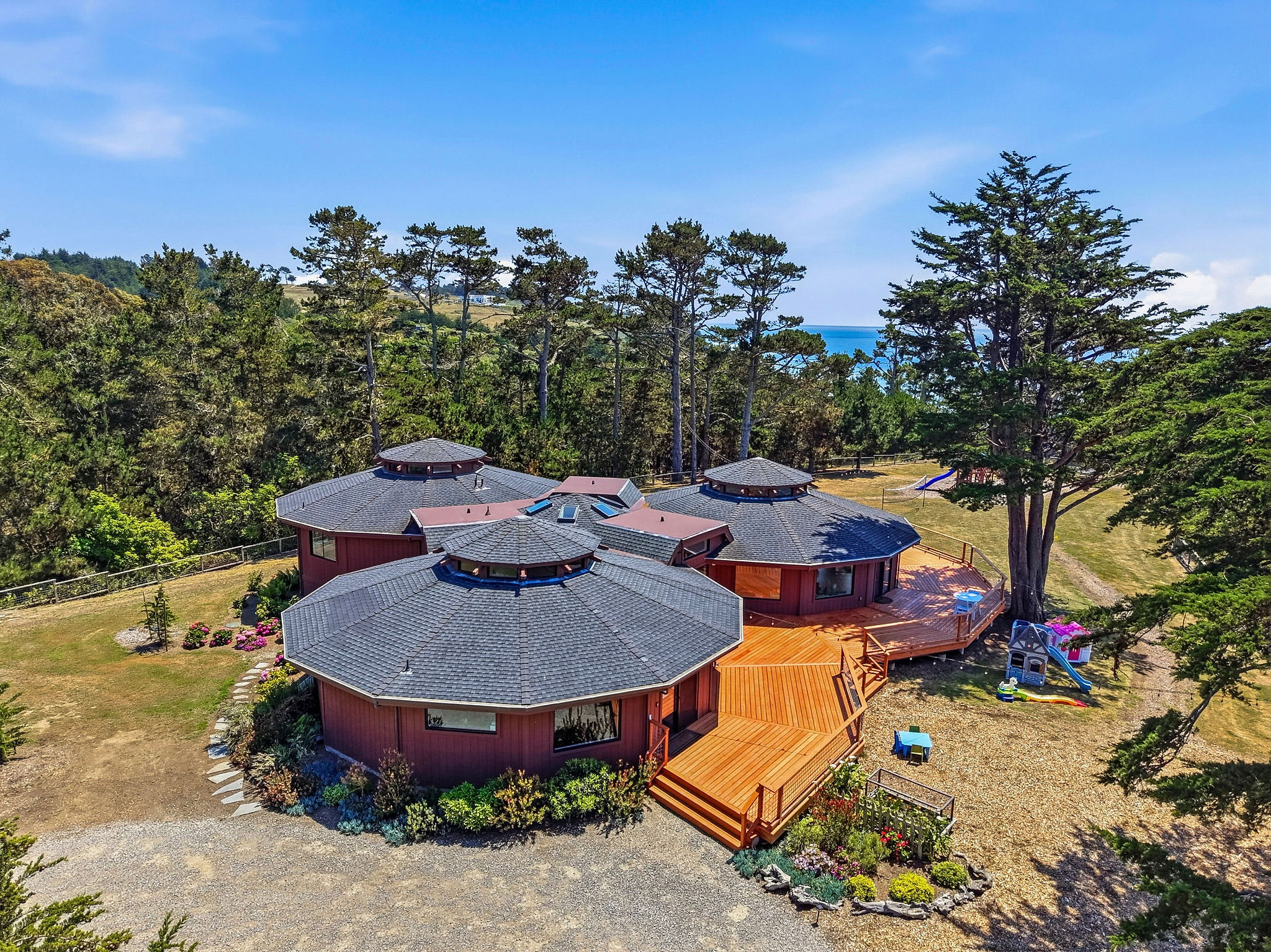 Unique octagonal retreat with expansive decks, privacy, and ocean glimpses