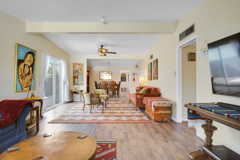 Massive but brightly colored living room, set up to encourage people to talk and hangout together. Television is secondary, but it is a 60", and Netflix, Prime, Disney+, ESPN+, Paramount+, Hulu, and Kanopy are provided.