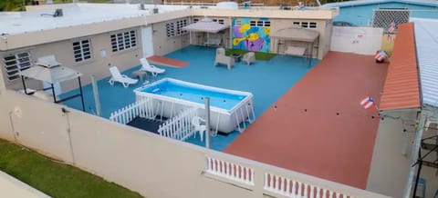 Very spacious patio with many amenities like swimming pool, grill, fire pit, pool table, dominoes table, outdoor furniture, bar.