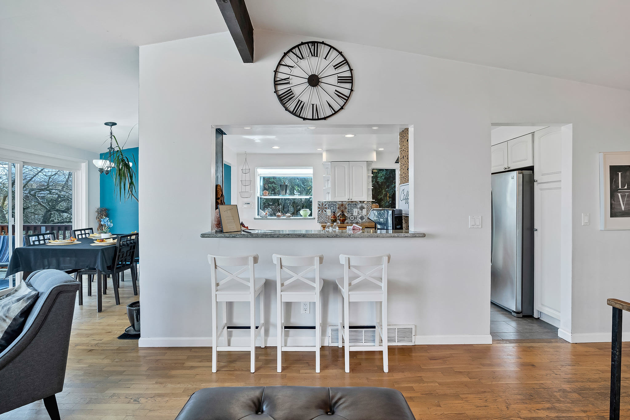 Bright open-concept living space with breakfast bar and sunny dining area