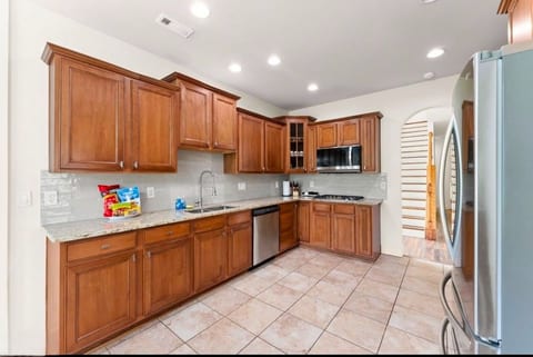 Bright gourmet kitchen with granite counters and stainless appliances