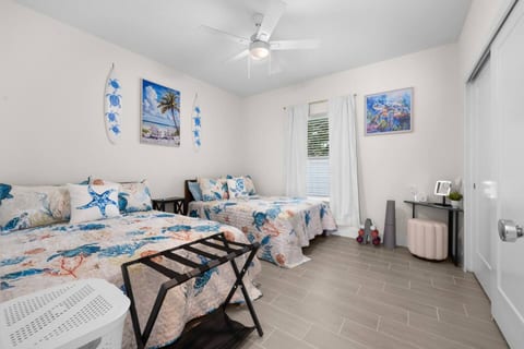 The 2nd bedroom includes two full beds, a spacious closet, and a convenient little makeup area.