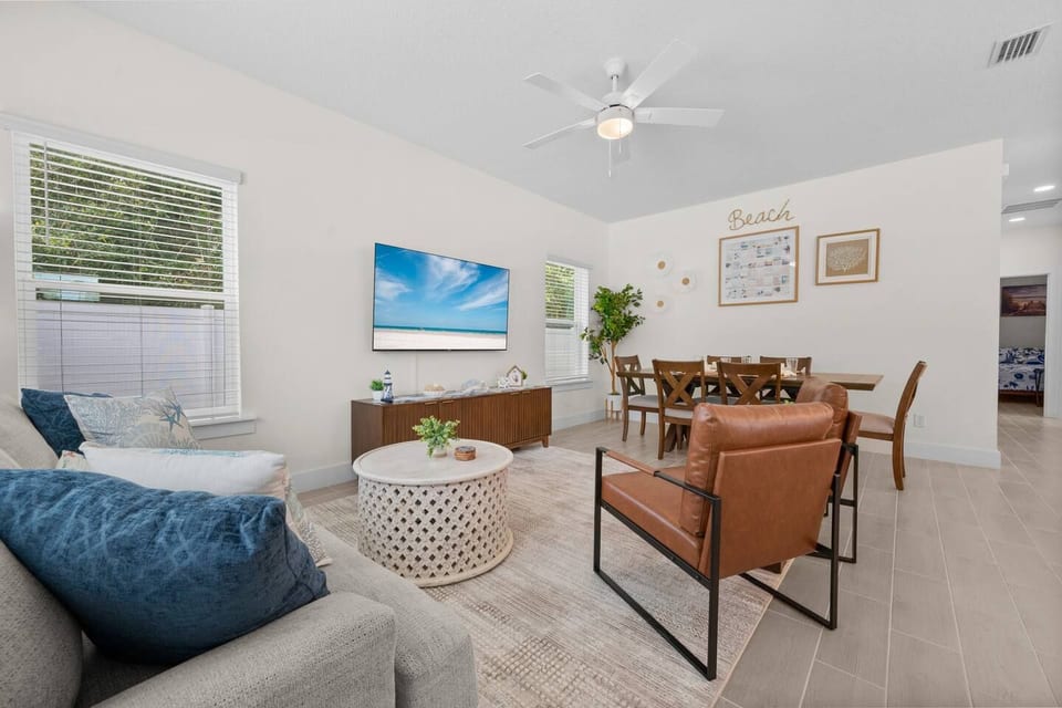 Relax in this welcoming living space with a soft sofa, two stylish sitting chairs, and a smart TV for movie nights. The room flows directly into the dining room, making it perfect for family time.