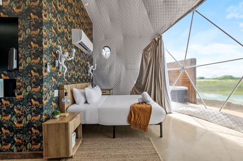Boutique dome bedroom with panoramic lake views and bold designer style