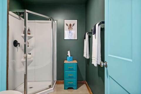 Stylish bathroom with glass shower, bold colors, and boutique-style touches
