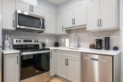 Bright modern kitchen with stainless appliances and coffee station
