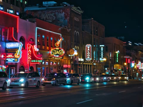 Steps to neon-lit nightlife, BBQ joints, and live music venues.
