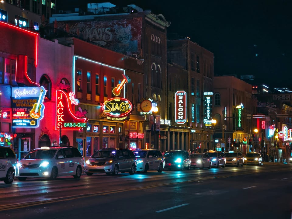 Steps to neon-lit nightlife, BBQ joints, and live music venues.