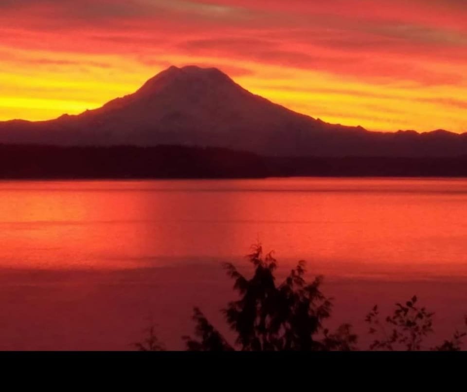 Our place is on the water with spectacular views of Puget Sound and Mount Rainier.  While the water views are always visible, the mountain view is weather-dependent and can be hidden by clouds at times.