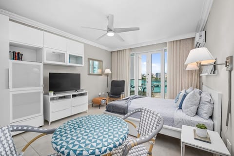 Bright bedroom with ocean views and a modern coastal design.
