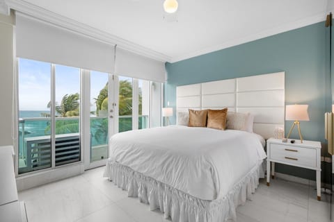 King bed with plush headboard and direct balcony access to ocean views