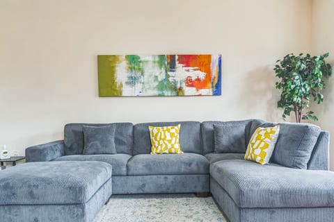 A bright and Cozy living room featuring a large sectional sofa for you to unwind after a long busy day.